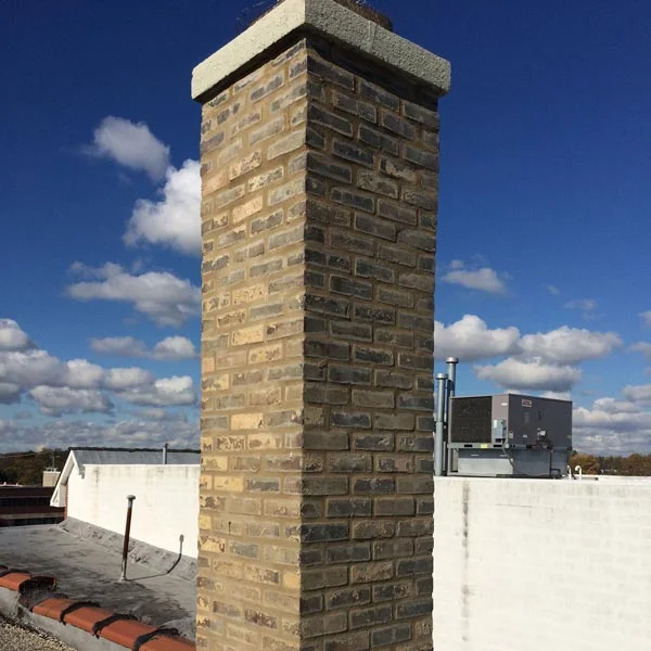 Close-up of newly replaced bricks on a chimney, highlighting meticulous masonry work in Chicago, IL